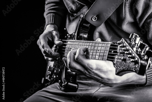 Musical instrument. Electric guitar. Repetition of rock music band. Music festival. Man playing guitar. Close up hand playing guitar. Musician playing guitar, live music