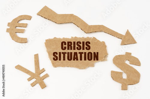 On a white background, currency symbols, an arrow and a cardboard box with the inscription - CRISIS SITUATION