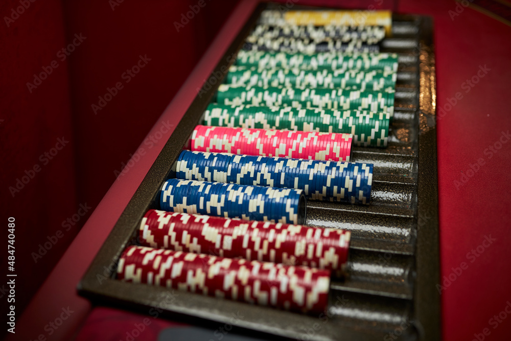 Colourful roulette chips in a casino on a gambling table. Lots of chips with different nomination and colours. multi-colored poker chips. casino chips. online casino, poker, gambling. Gaming table Colourful roulette chips in a casino on a gambling table. Lots of chips with different nomination and colours. multi-colored poker chips. casino chips. online casino, poker, gambling. Gaming table