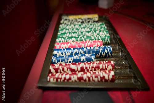 Colourful roulette chips in a casino on a gambling table. Lots of chips with different nomination and colours. multi-colored poker chips. casino chips. online casino, poker, gambling. Gaming table