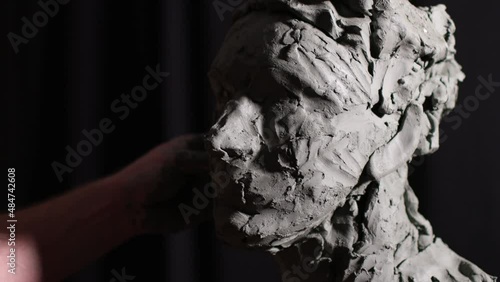 Man sculptor creates sculpt bust clay human woman sculpture. Statue craft creation workshop.