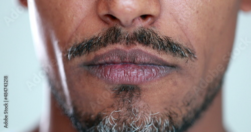 Upset mixed race man becoming serious close-up mouth  person changing mood  from happy to serious