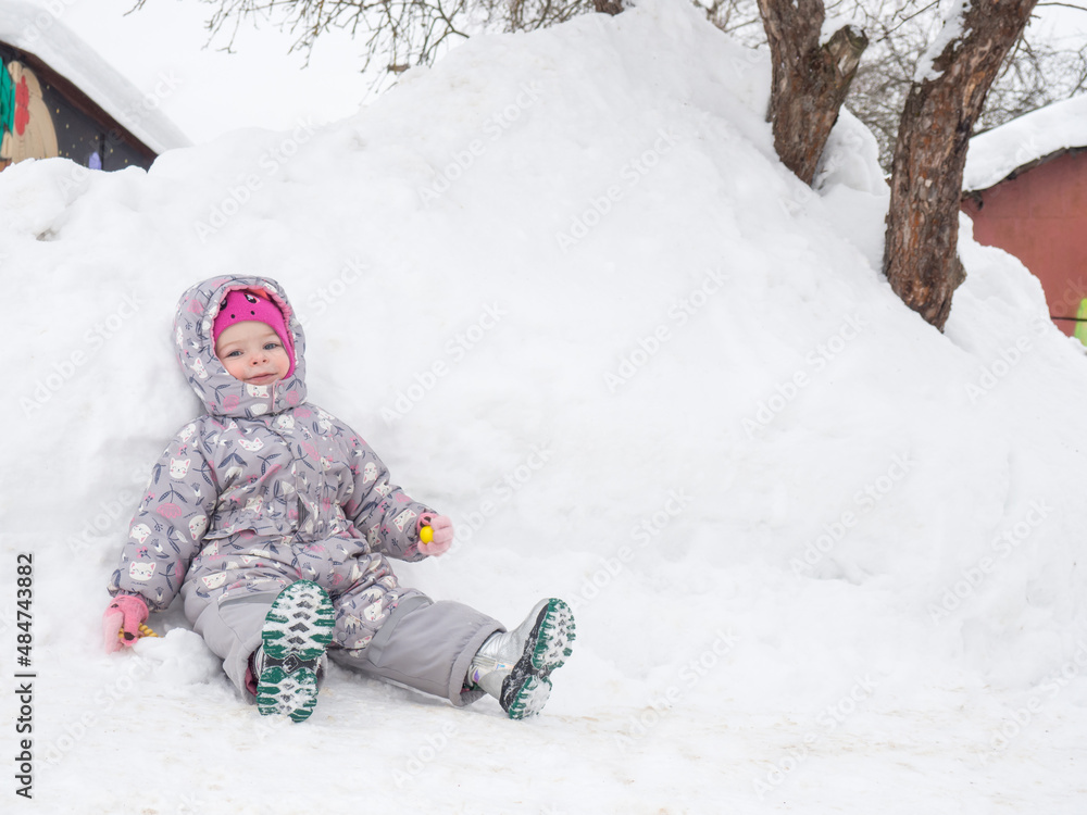 beautiful two year old child is tired and resting in the snow copy space beautiful two year old child is tired and resting in the snow copy space