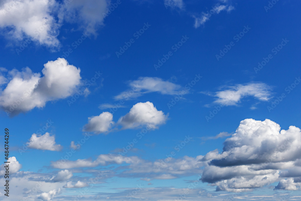 blue sky with white cumulus clouds of various sizes as a natural background blue sky with white cumulus clouds of various sizes as a natural background