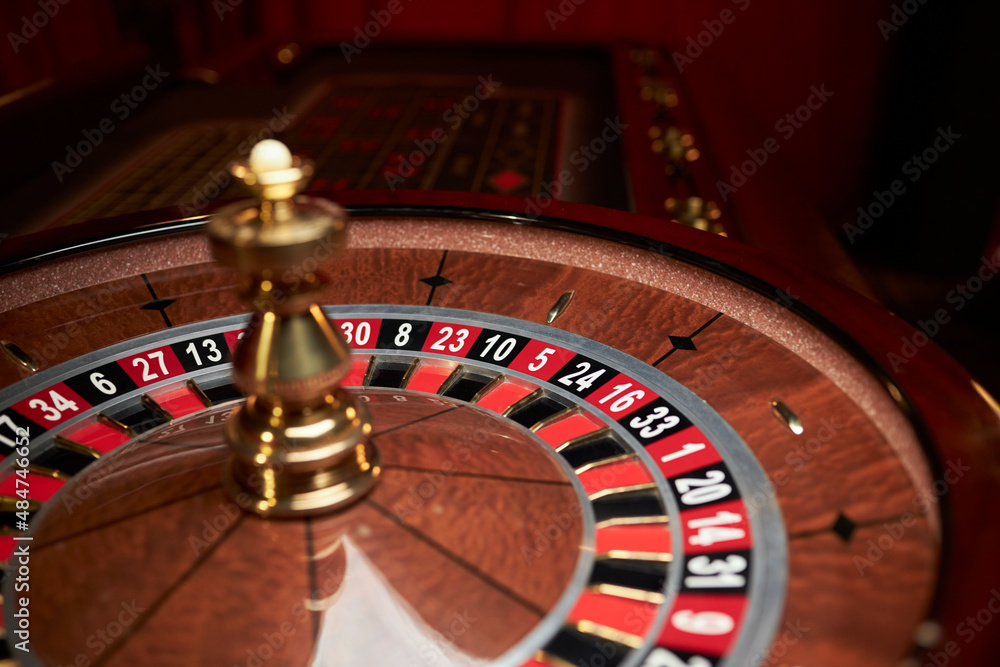 casino roulette wheel, casino gambling concept. Roulette table in a casino, with many games and slots, roulette wheel in the foreground. Casino roulette close-up. gambling for money. casino roulette wheel, casino gambling concept. Roulette table in a casino, with many games and slots, roulette wheel in the foreground. Casino roulette close-up. gambling for money.