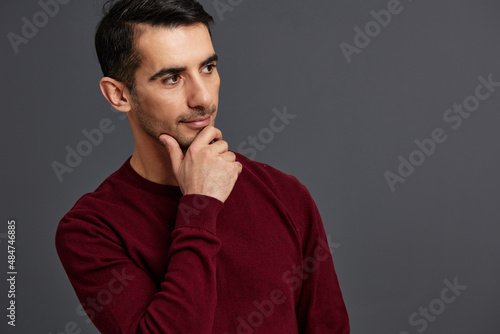 portrait man posing smile gesture hands red sweater cropped view