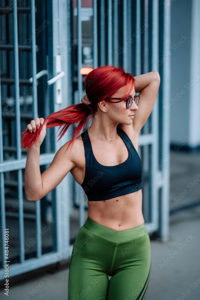 Portrait of fit and attractive fitness woman working out. Professional trainer woman working out and stretching