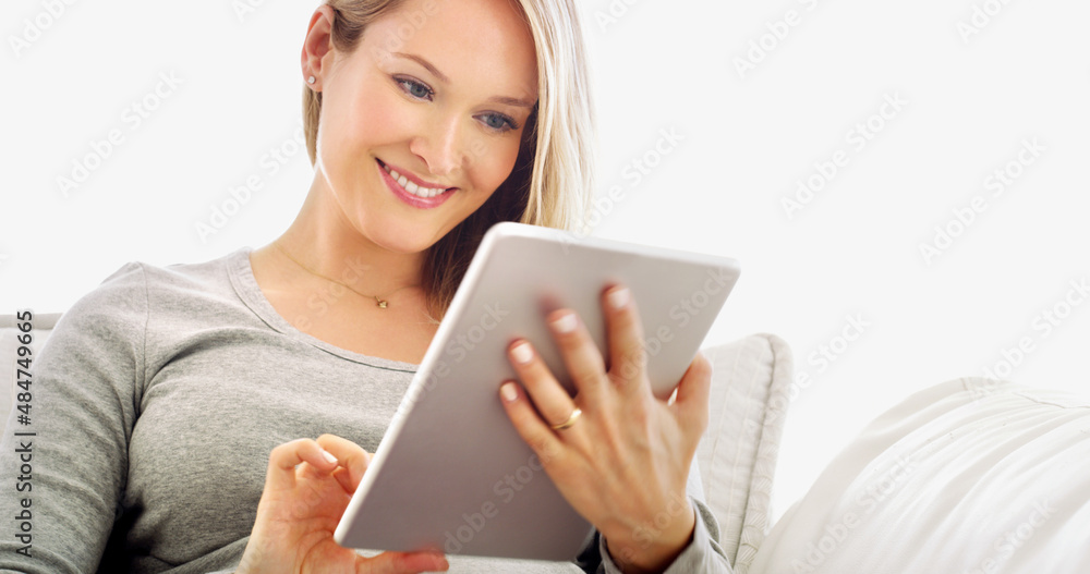 Convenience at my fingertips. Cropped portrait of an attractive young woman using a tablet in her home. Convenience at my fingertips. Cropped portrait of an attractive young woman using a tablet in her home.