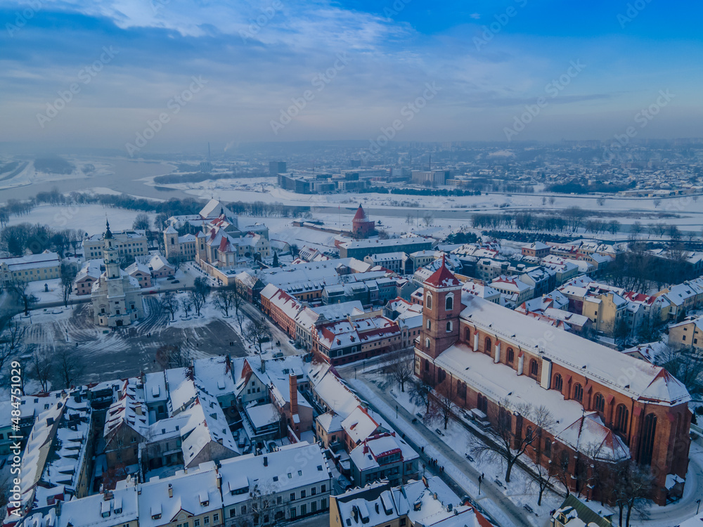 Aerial panorama of Kaunas city (Lithuania) old town, located in confluence of two river. City hall in the main square, cathedral, other churches and snowy roofs.