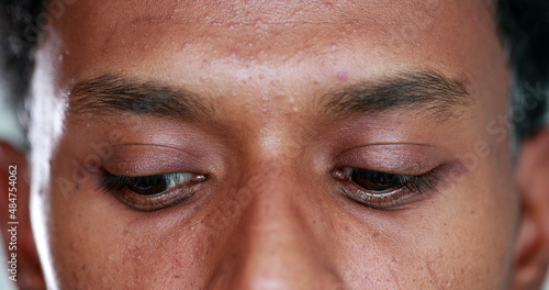 Foto Extreme close-up of african american man eyes looking up , down and sideways