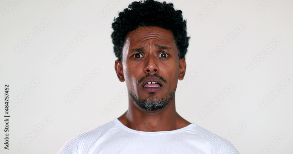 Obraz premium African man reacting with terror and horror to camera, black guy shock reaction