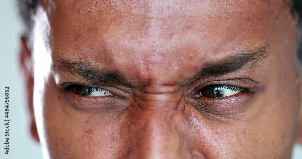 African man eyes squinting. Close-up black guy closing eyes squint African man eyes squinting. Close-up black guy closing eyes squint