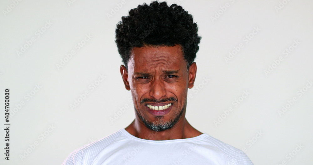 Obraz premium African american gradual shock reaction, face emotion black guy reacting with horror putting hand in mouth with surprise