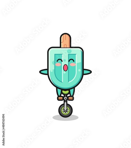 The cute popsicles character is riding a circus bike