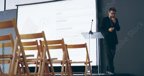 Is it too late to cancel the speech? Stressed and nervous businessman speaker preparing for a speech, feeling scared and worried. Man preparing for business speech, public speaking fear concept photo