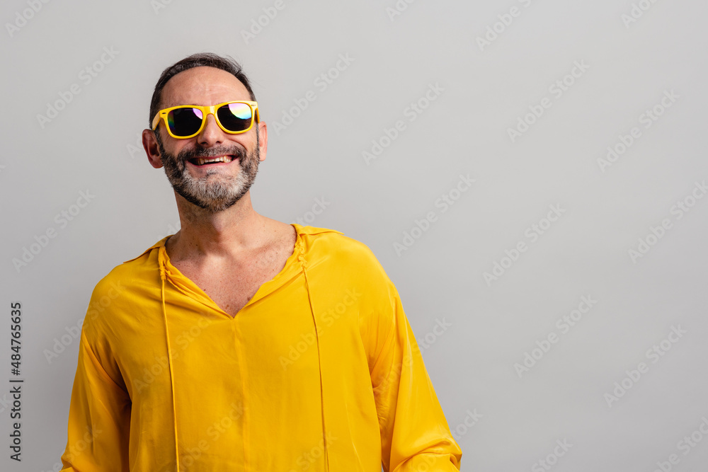 Stylish senior man wearing yellow shit and smiling Stylish senior man wearing yellow shit and smiling