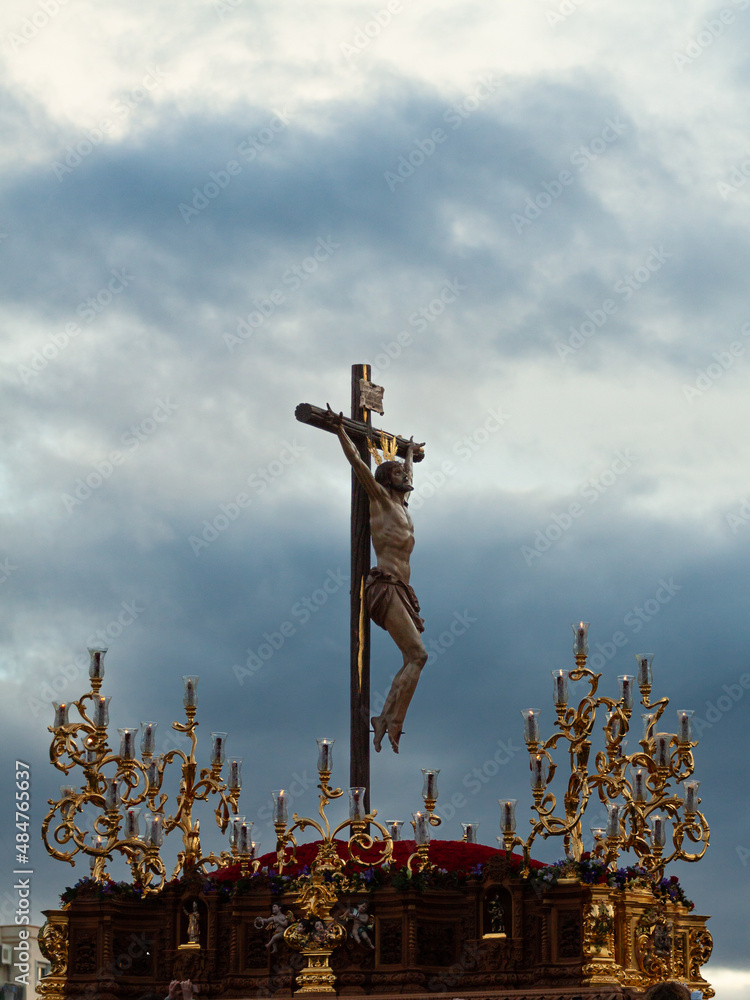 Fototapeta premium sculpture of jesus christ crucified in the easter procession in granada,sevilla,andalucia,spain. holy week in sevilla and granada. Vertical photography with copy space