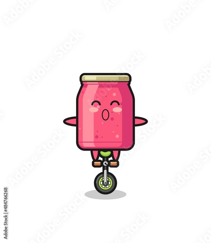 The cute strawberry jam character is riding a circus bike