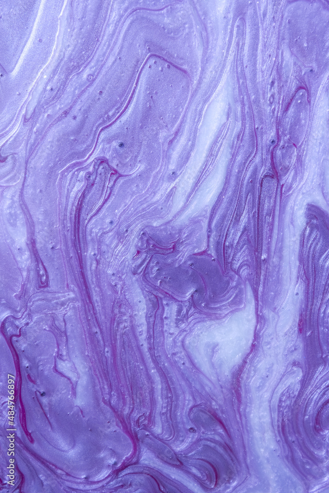 Liquid abstract background made of purple glitter nail polish