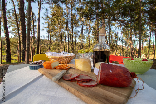 Traditional portuguese sausage board, in the middle of the woods for a traditional portuguese snack photo