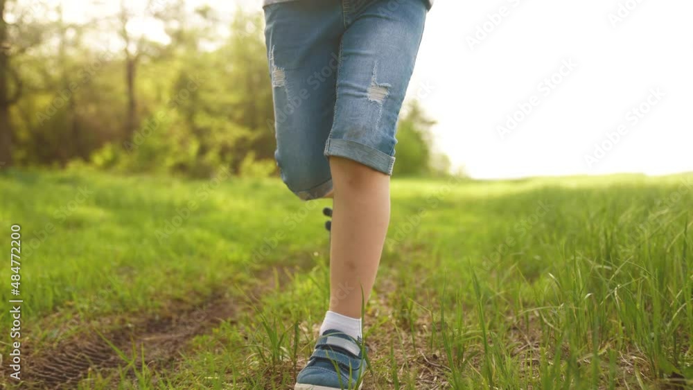 happy family. kid run legs close-up in the park at sunset. lifestyle people in the park concept boy son joyful run. happy family summer. little baby run child fun summer kid dream concept happy family. kid run legs close-up in the park at sunset. lifestyle people in the park concept boy son joyful run. happy family summer. little baby run child fun summer kid dream concept