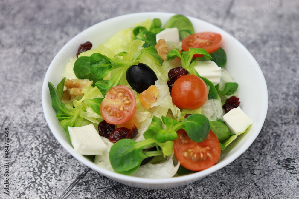 Healthy fresh salad of fresh sprouts, cherry, lettuce, mango, cheese, healthy food concept.