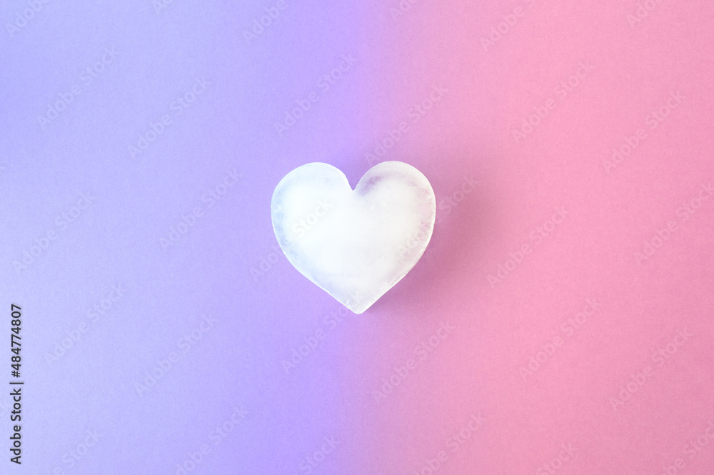 Icy heart on a combination of purple and pink background colors. Valentines ice love aesthetic concept. Visual vibrant colors.