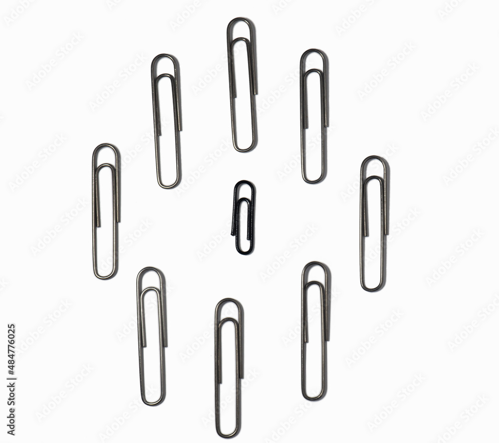 Large paper clips on a white background. Office supplies isolate. Paper fastening. Goods for business Large paper clips on a white background. Office supplies isolate. Paper fastening. Goods for business