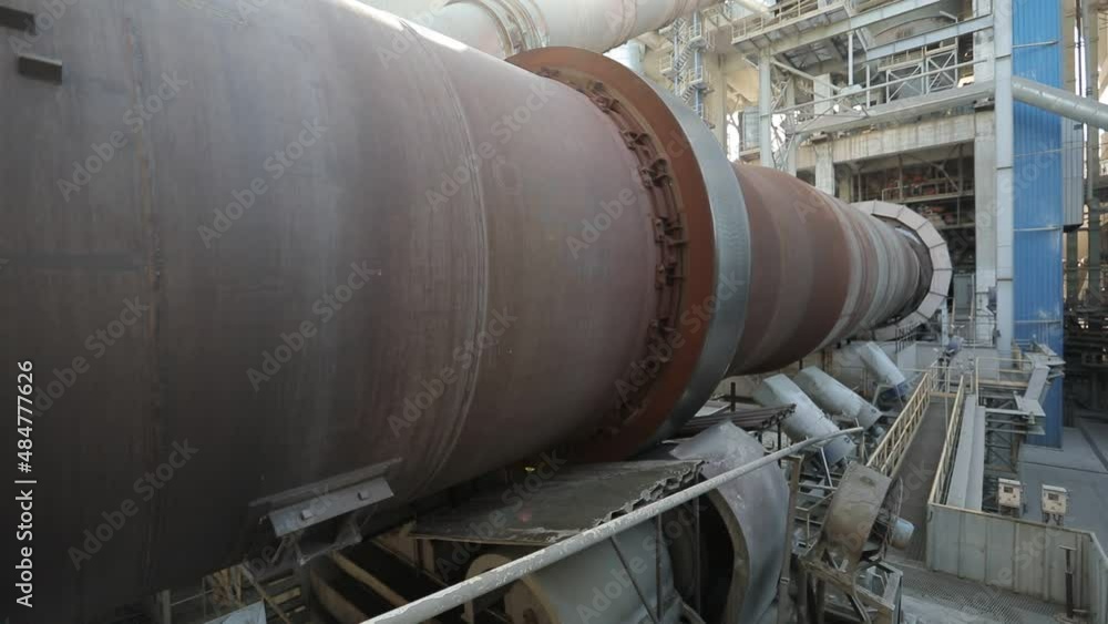 Big tube working in the big factory. Pipe is turning. Pipe transporting raw materials. Tube transporting liquid. Big tube working in the big factory. Pipe is turning. Pipe transporting raw materials. Tube transporting liquid.