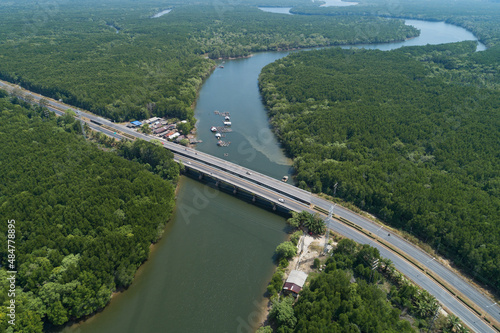 Aerial top down drone shot of bridge with cars on bridge highway road and landscape mountain view nature image transportation background and business travel concept