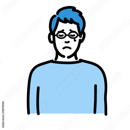 悲しそうに涙を流しているメガネをかけた若い男性
