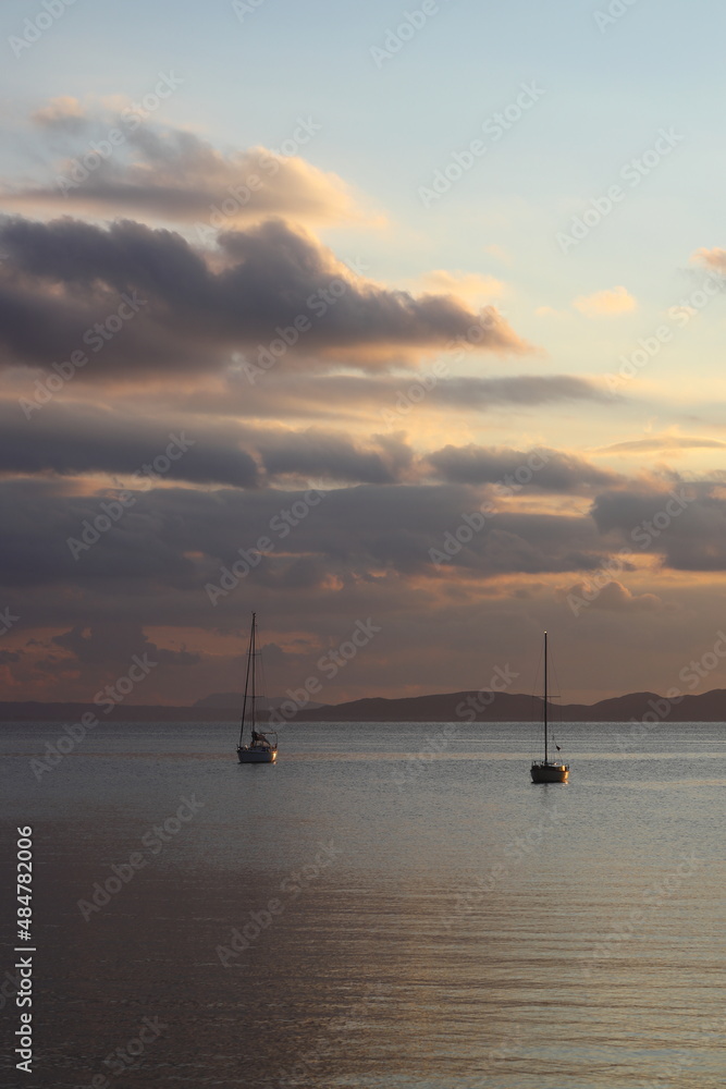 Alone sailboat at sunset. Atmospheric seascape with reflection	

