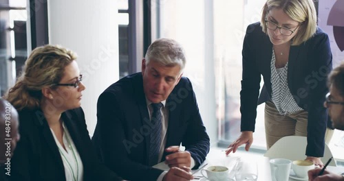 He doesnt shy away from having candid business conversations. Diverse group of business people sitting in office and having a boardroom meeting. Colleagues sitting and discussing, strategy, plan photo