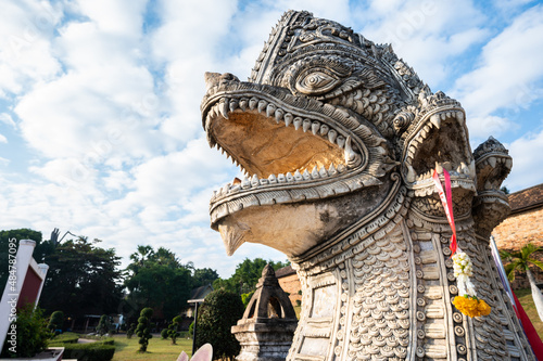 Large Naga statue in front of Wat Phra That Lampang Luang temple in Lampang province of Thailand. Nagas are the serpent creatures that stand guard at all the Buddhist wats in Thailand.