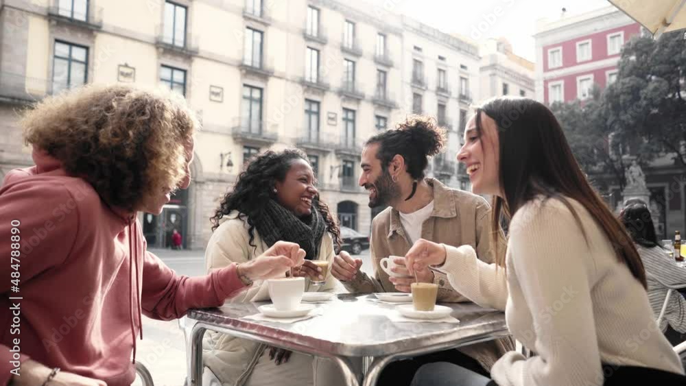Friends group toasting latte at coffee bar terrace. Group of people talking and having fun together at cappuccino restaurant. Lifestyle concept with happy men and women