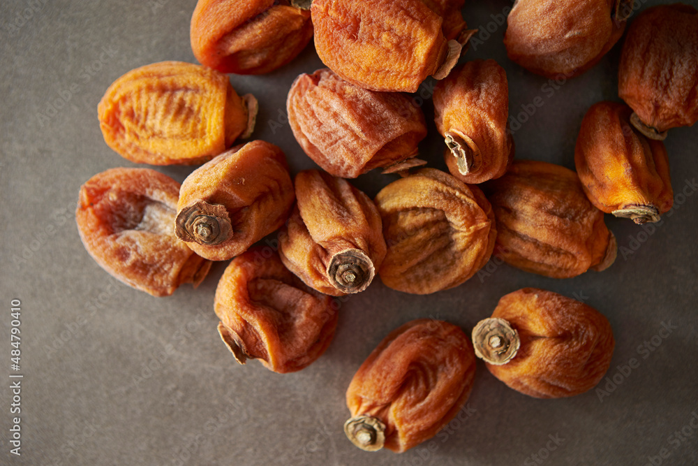 dried persimmons on a gray background dried persimmons on a gray background