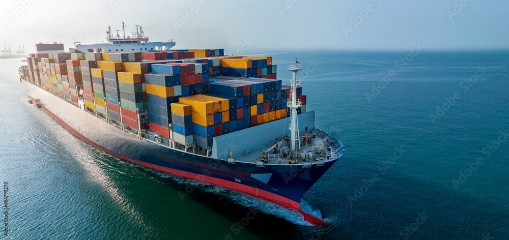 Aerial side view of cargo ship carrying container and running for export  goods  from  cargo yard port to custom ocean concept technology transportation , customs clearance. - obrazy, fototapety, plakaty 