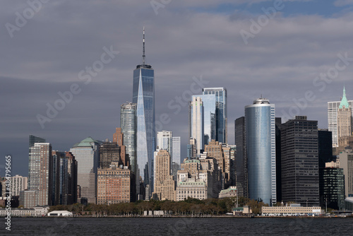 Manhattan s skyline with cloudy sky at sunset