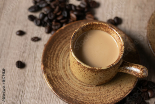 hot coffee in brown cup on wooden background