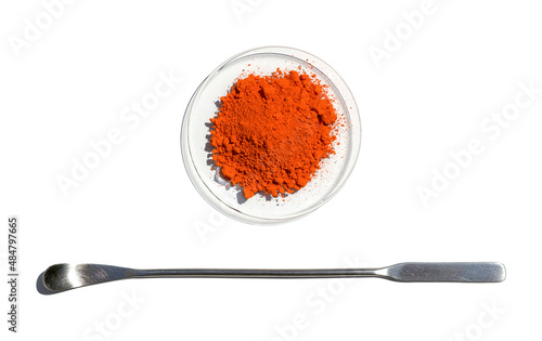 Closeup chemical ingredient on white laboratory table. Lead(II,IV) oxide in Chemical Watch Glass place next to the stainless spatula. Top View photo