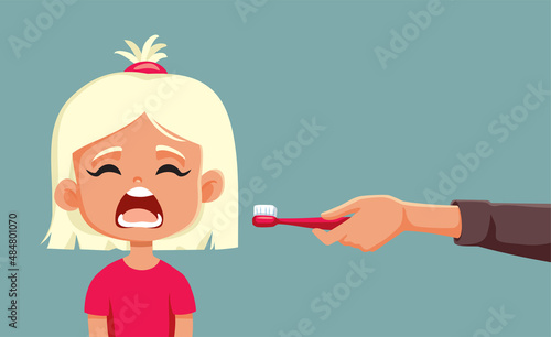 Parent Holding a Toothbrush Explaining his Daughter Dental Care