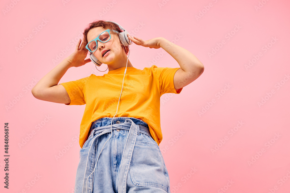 pretty woman yellow t-shirt headphones entertainment music fun pink background unaltered pretty woman yellow t-shirt headphones entertainment music fun pink background unaltered
