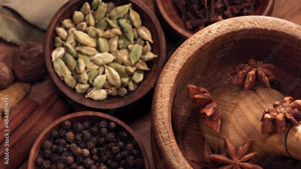 Wood Mortar and Star Anise Spice Species Falling in Slow Motion Wood Mortar and Star Anise Spice Species Falling in Slow Motion