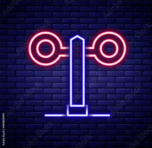 Glowing neon line Train traffic light icon isolated on brick wall background. Traffic lights for the railway to regulate the movement of trains. Colorful outline concept. Vector