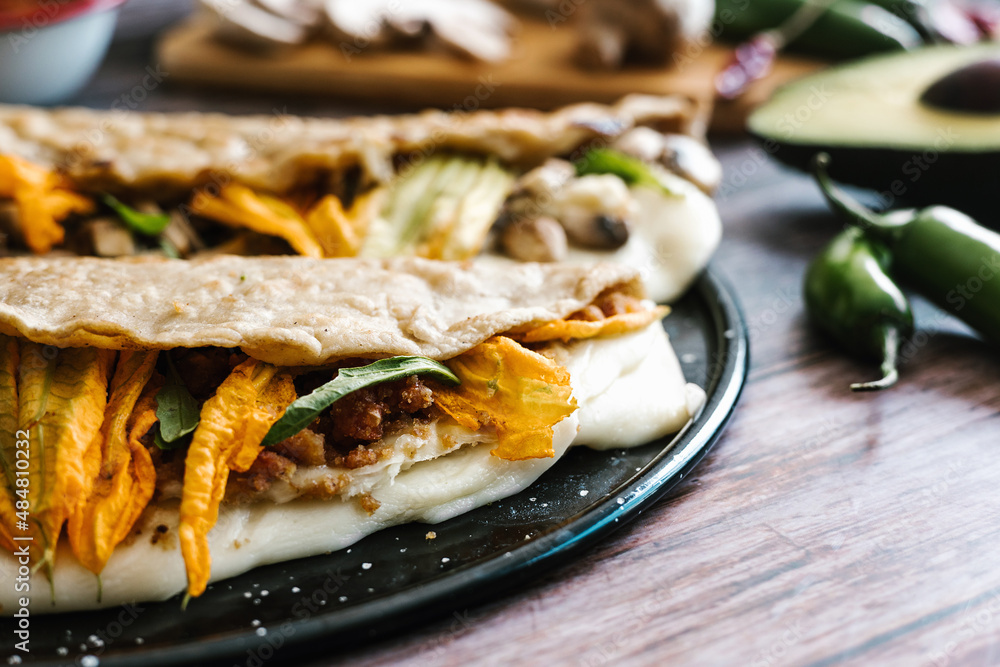 Mexican chicharrón quesadilla with oaxaca cheese and squash blossom