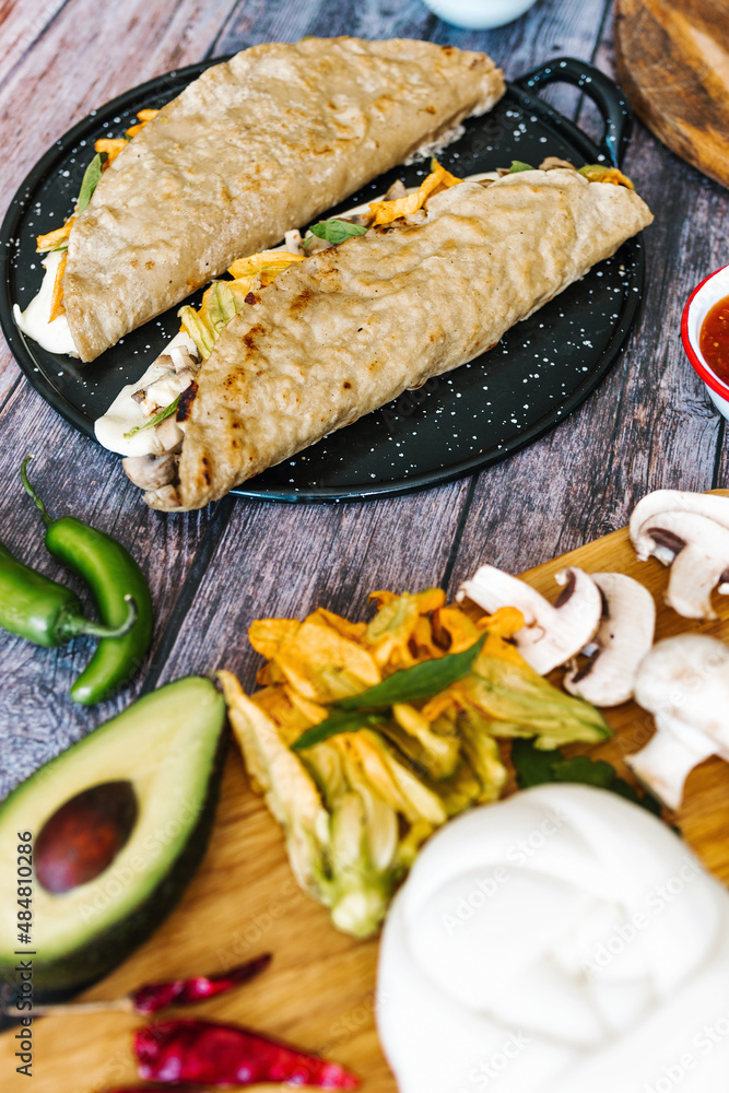 Mexican chicharrón quesadilla with oaxaca cheese and squash blossom