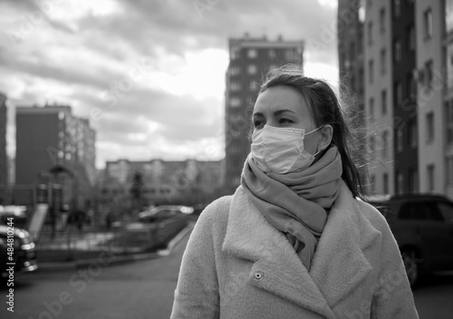 Shot of a girl in a mask, on the street. lockdown Covid-19 pandemic. © Evgeny Leontiev