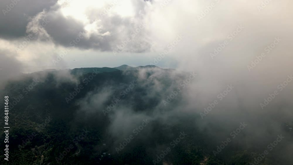 High white clouds on a sunny day over the green tourist island of Koh Pha Ngan. Drone lowering tilt shot High white clouds on a sunny day over the green tourist island of Koh Pha Ngan. Drone lowering tilt shot