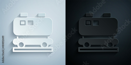 Paper cut Oil railway cistern icon isolated on grey and black background. Train oil tank on railway car. Rail freight. Oil industry. Paper art style. Vector