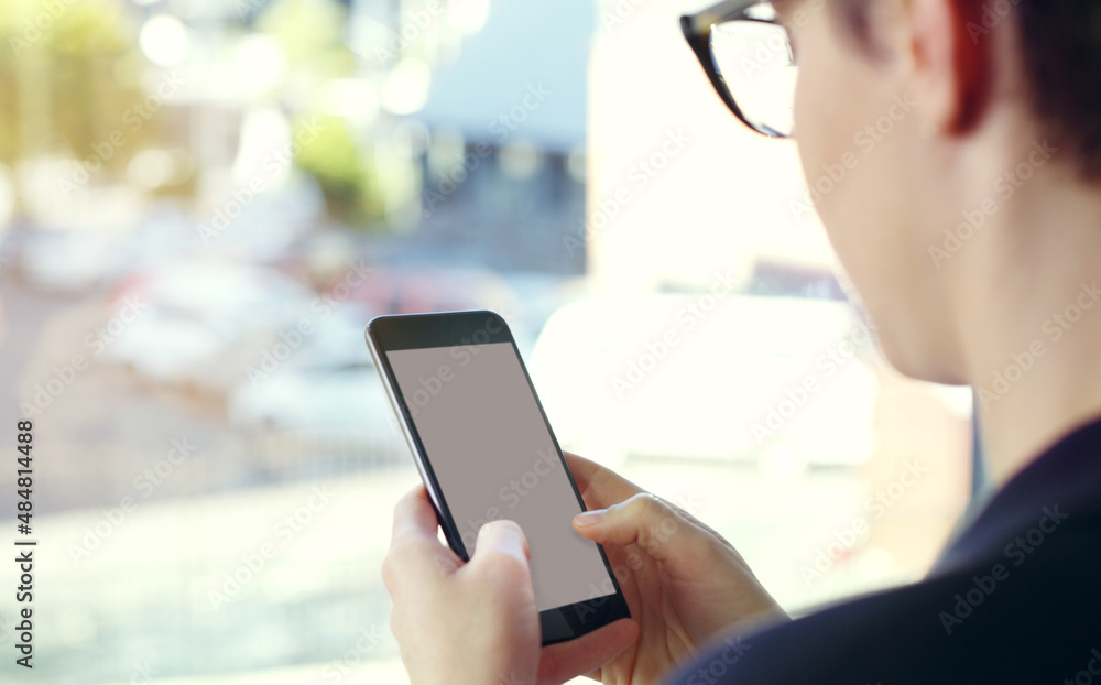 She makes herself available to her clients. Cropped shot of an unrecognizable young businesswoman using a mobile phone while standing on her office balcony. She makes herself available to her clients. Cropped shot of an unrecognizable young businesswoman using a mobile phone while standing on her office balcony.